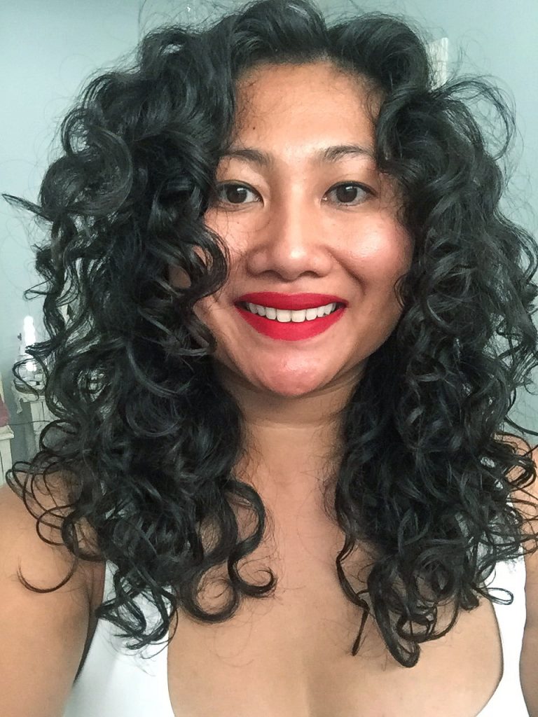 Rosie, an Asian woman with curly hair