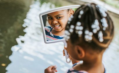 Photo of girl looking in mirror